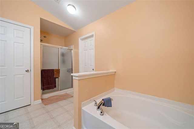 bathroom with lofted ceiling and separate shower and tub