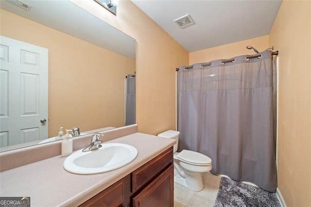 bathroom with curtained shower, vanity, and toilet