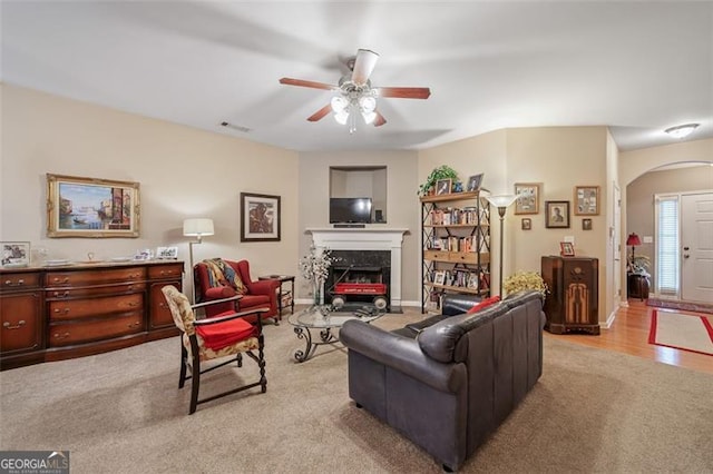 living room with light wood-type flooring and ceiling fan