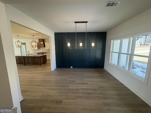 unfurnished dining area with sink and dark hardwood / wood-style flooring