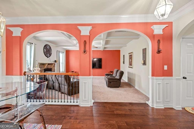 interior space with beamed ceiling, dark hardwood / wood-style floors, crown molding, and coffered ceiling