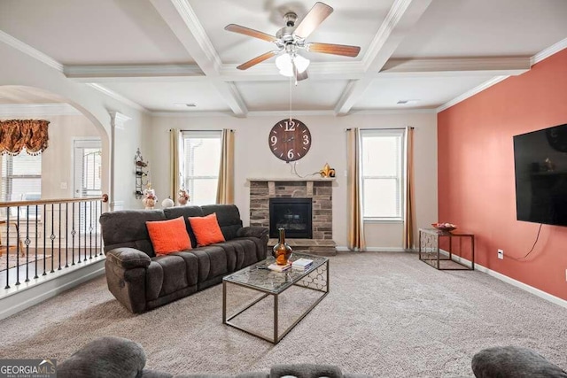 living room featuring a wealth of natural light, beamed ceiling, and carpet flooring