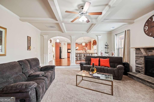 carpeted living room with ornate columns, coffered ceiling, beamed ceiling, crown molding, and ceiling fan