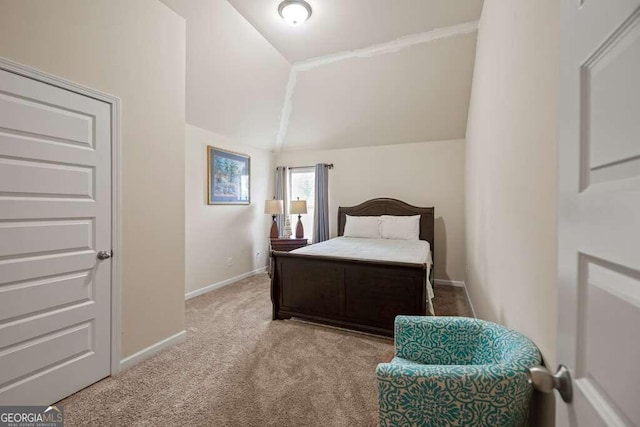 bedroom with carpet, lofted ceiling, and baseboards