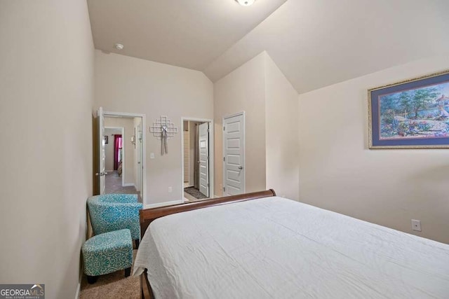 bedroom featuring baseboards and vaulted ceiling