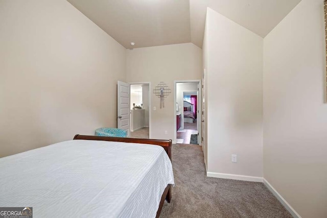 carpeted bedroom with vaulted ceiling and baseboards