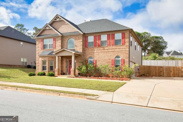 craftsman house featuring a garage and a front yard