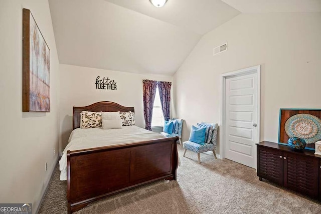 bedroom featuring light colored carpet, lofted ceiling, and visible vents