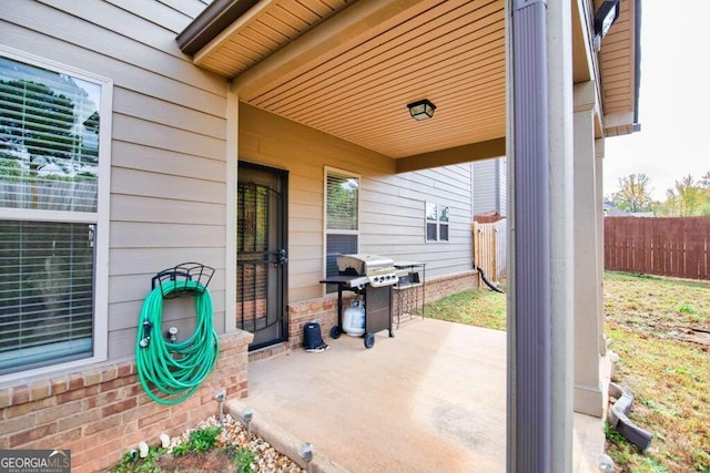 view of patio with fence and area for grilling