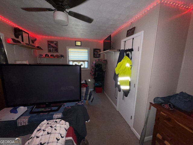 bedroom featuring ceiling fan, a textured ceiling, and carpet flooring