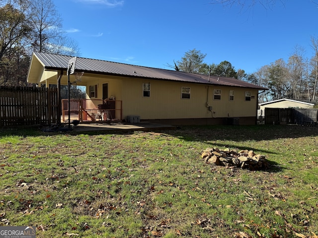 rear view of house with a lawn and a patio