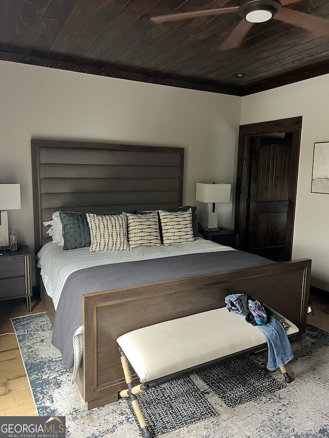 bedroom with wooden ceiling, hardwood / wood-style flooring, and ceiling fan