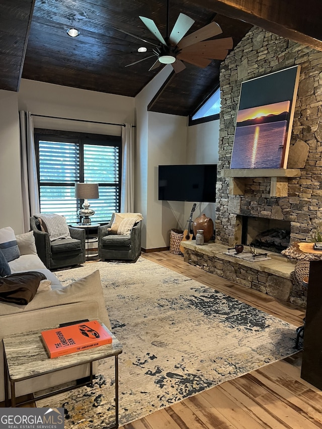 living room featuring a fireplace, hardwood / wood-style flooring, ceiling fan, and high vaulted ceiling