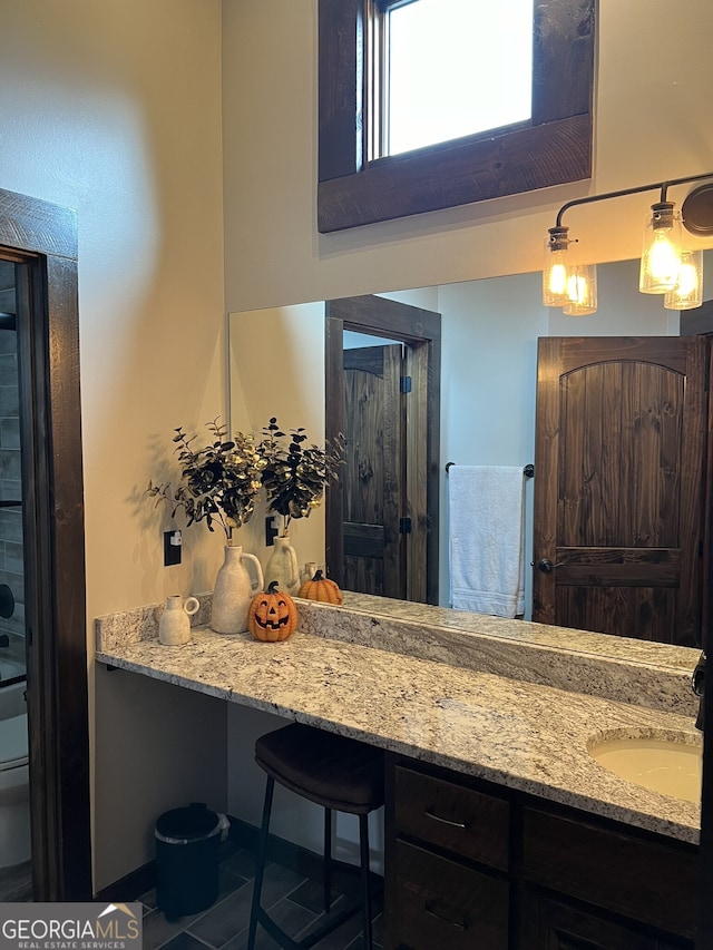 bathroom featuring toilet, vanity, and tile patterned flooring