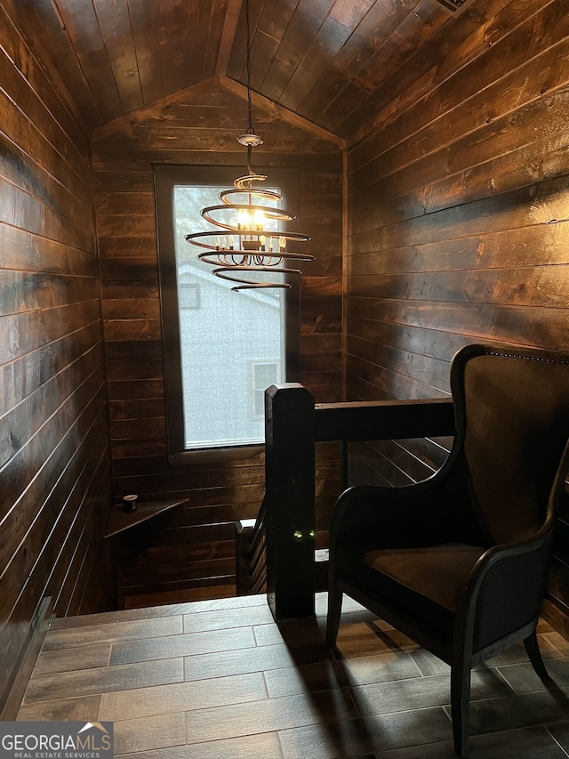 dining space featuring wooden walls, an inviting chandelier, hardwood / wood-style flooring, lofted ceiling, and wooden ceiling