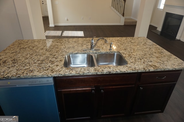 kitchen featuring dark brown cabinets, dark hardwood / wood-style floors, sink, and dishwasher