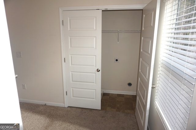 laundry room with electric dryer hookup and dark carpet