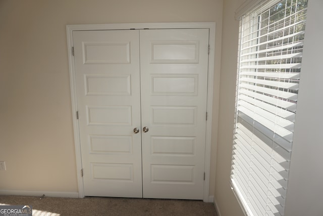 doorway to outside featuring carpet