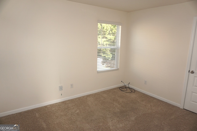 unfurnished room featuring carpet