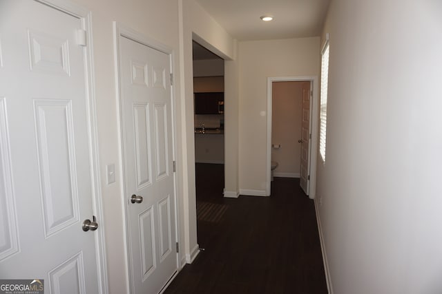 hall with dark hardwood / wood-style flooring