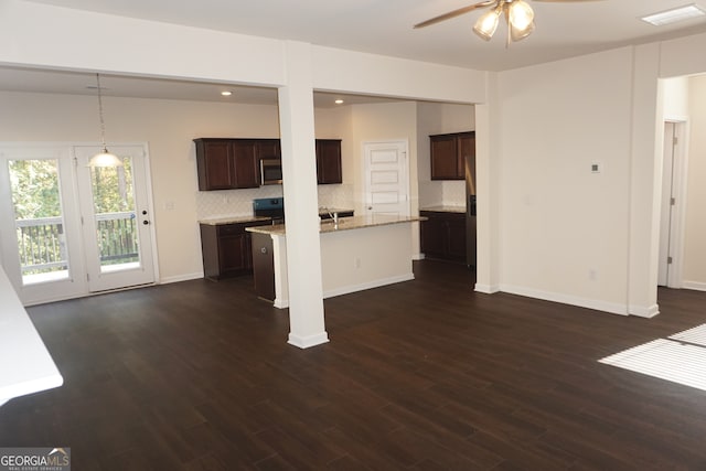 unfurnished living room featuring dark hardwood / wood-style flooring and ceiling fan