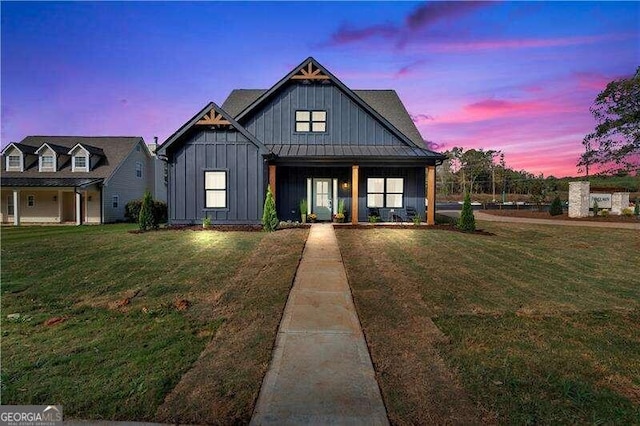 modern farmhouse style home featuring a yard