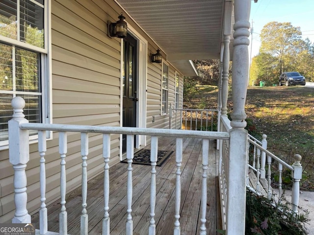 wooden terrace featuring covered porch