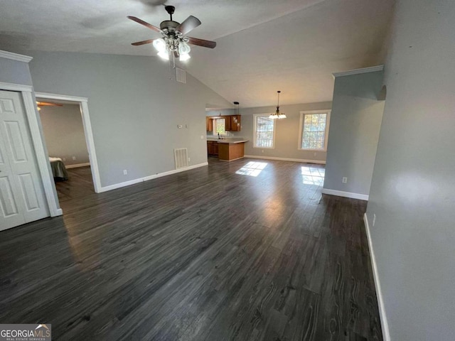 unfurnished living room featuring dark hardwood / wood-style floors, ceiling fan with notable chandelier, and lofted ceiling