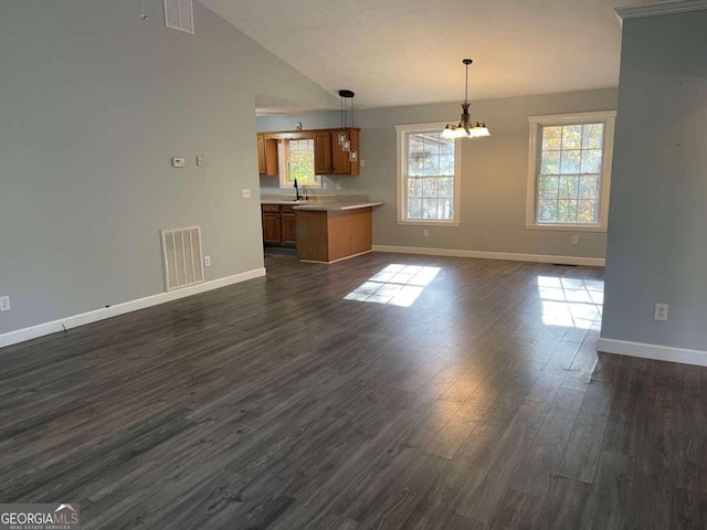 unfurnished living room with lofted ceiling, a chandelier, sink, and dark hardwood / wood-style flooring