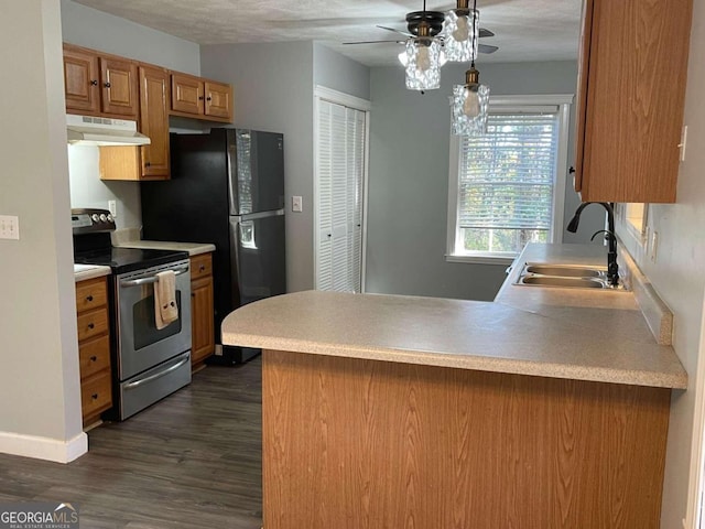 kitchen with stainless steel appliances, dark hardwood / wood-style flooring, kitchen peninsula, a textured ceiling, and sink