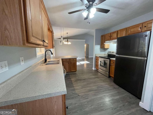 kitchen with sink, appliances with stainless steel finishes, hanging light fixtures, vaulted ceiling, and dark hardwood / wood-style flooring