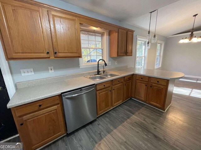 kitchen with dark hardwood / wood-style floors, hanging light fixtures, sink, dishwasher, and kitchen peninsula