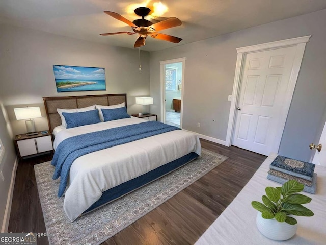 bedroom with dark hardwood / wood-style flooring, ceiling fan, and ensuite bathroom