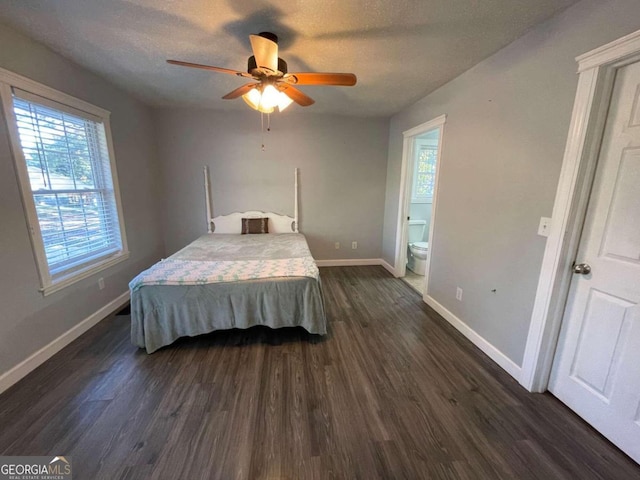 bedroom with dark wood-type flooring, ceiling fan, and multiple windows