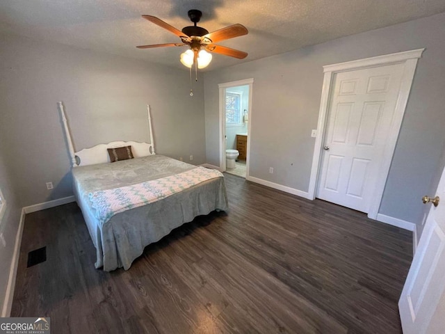 bedroom with ceiling fan, ensuite bath, dark hardwood / wood-style floors, and a textured ceiling