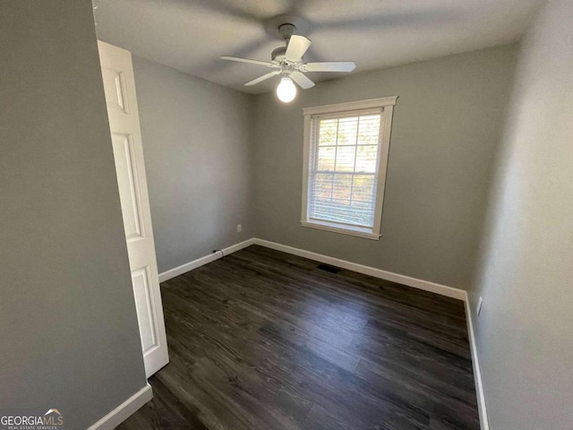 unfurnished room featuring dark hardwood / wood-style floors and ceiling fan