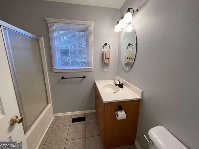 full bathroom featuring tile patterned flooring, vanity, combined bath / shower with glass door, and toilet