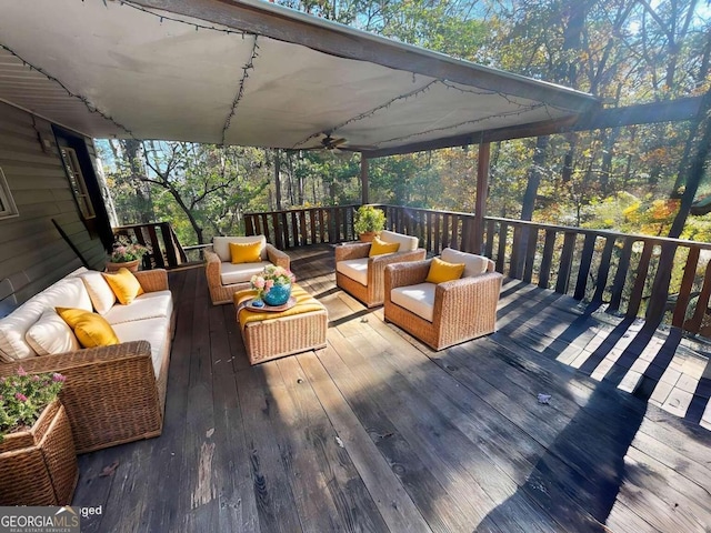 wooden terrace with outdoor lounge area and ceiling fan