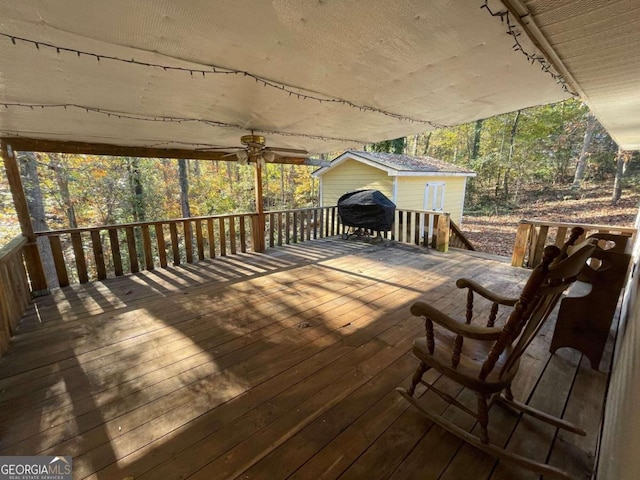 wooden deck featuring a grill and ceiling fan