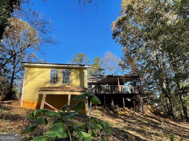 rear view of property with a wooden deck