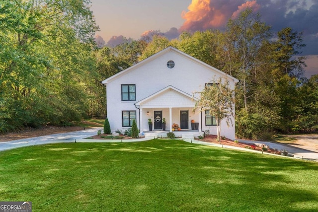 view of front of house featuring a porch and a yard