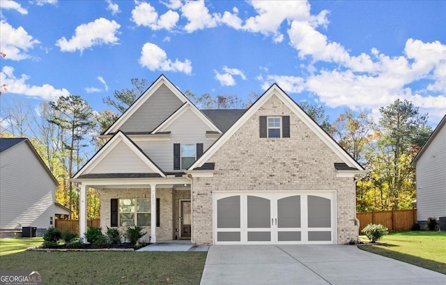 craftsman-style house with cooling unit, a garage, a front lawn, and covered porch