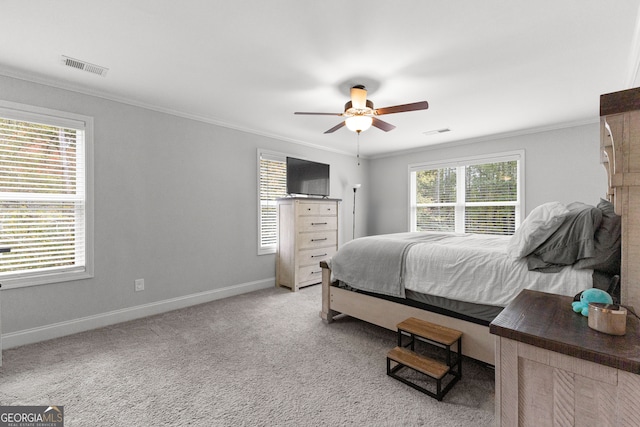 carpeted bedroom with ornamental molding, multiple windows, and ceiling fan