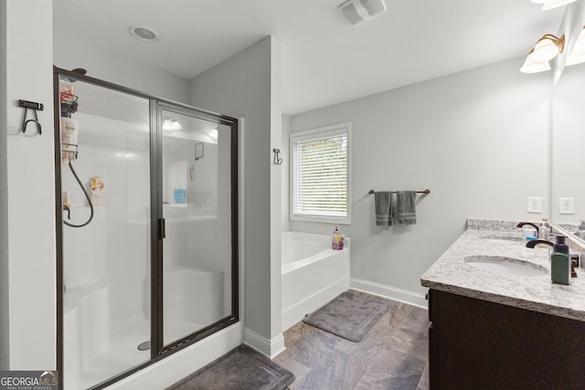 bathroom featuring vanity and plus walk in shower