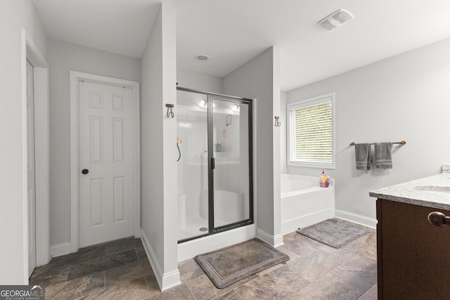 bathroom with vanity and separate shower and tub