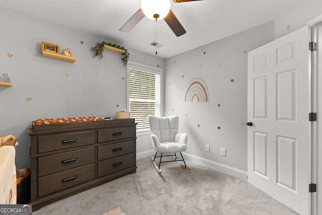 sitting room featuring light carpet and ceiling fan