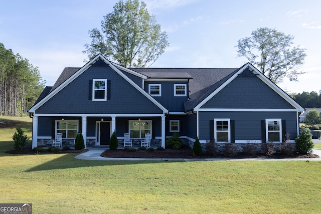 craftsman house with a porch and a front lawn