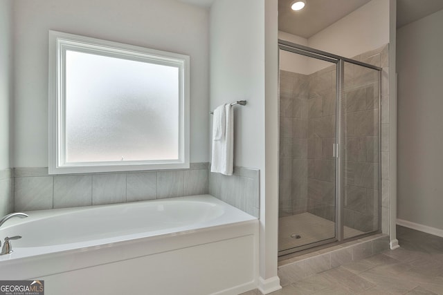 bathroom featuring tile patterned flooring and plus walk in shower