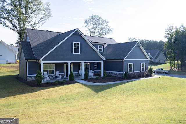 craftsman-style home featuring a front yard and covered porch