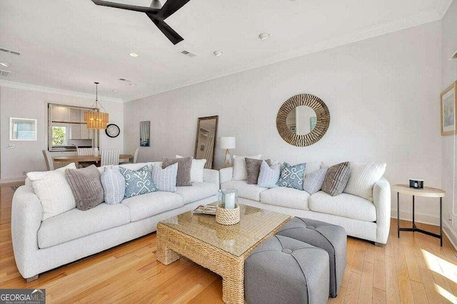 living room featuring light wood-type flooring and ornamental molding